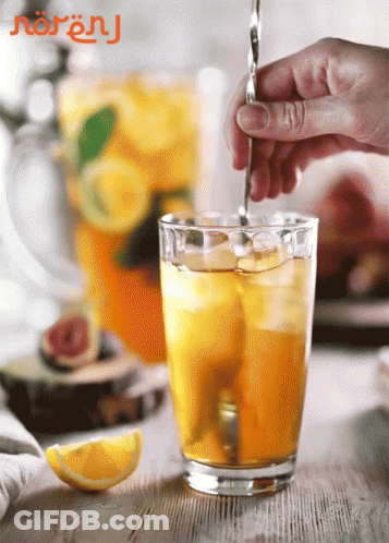 Person Pouring Drink Into Glass With Ice GIF