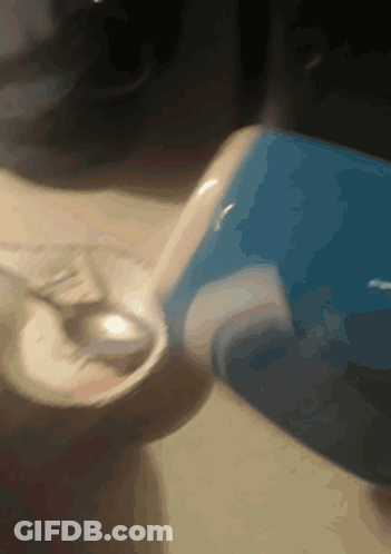 Person Pouring Into Glass With Blue Container GIF