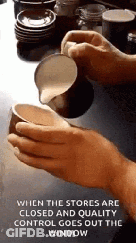 Person Pouring Milk Into Cup Of Coffee GIF