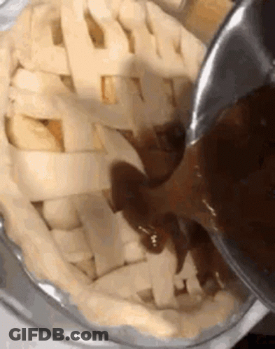 Person Pouring Sauce Into Pie GIF