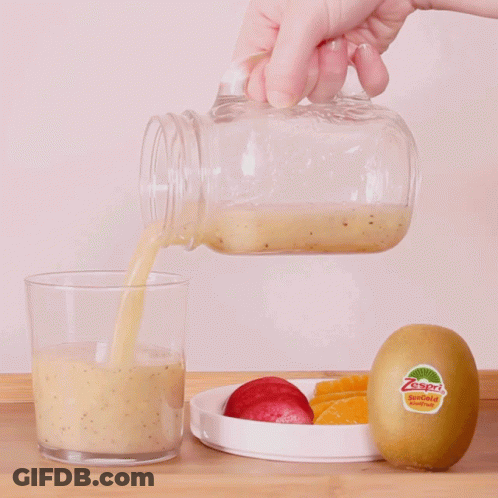 Person Pouring Smoothie Into Glass With Kiwi GIF