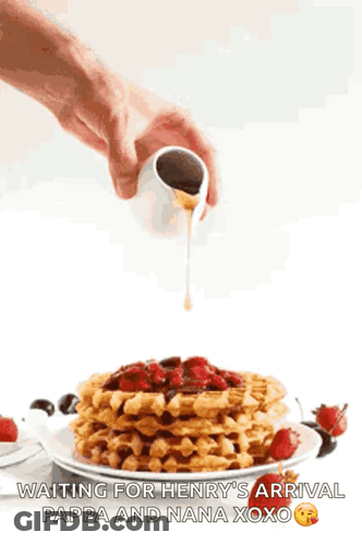 Person Pouring Syrup Over Waffles With Strawberries GIF