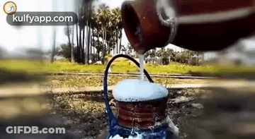 Person Pouring Water From Bottle Into Teapot GIF