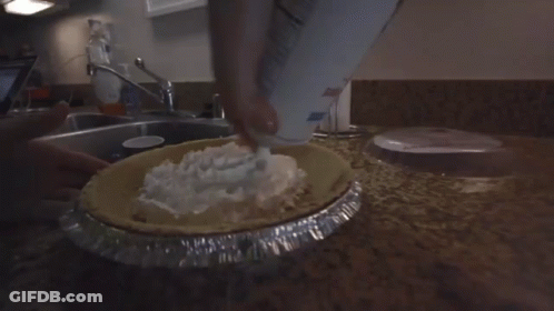 Person Pouring Whipped Cream Into Pie GIF