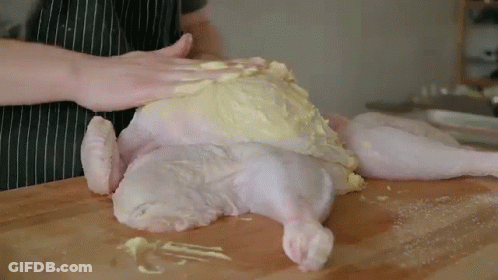 Person Preparing Chicken On Cutting Board GIF
