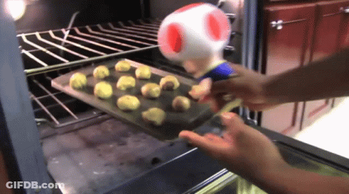 Person Putting Cookies In Oven With Toad GIF