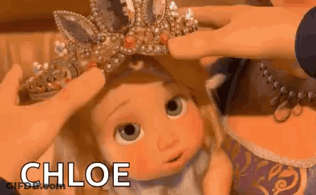 Person Putting Crown On Doll GIF