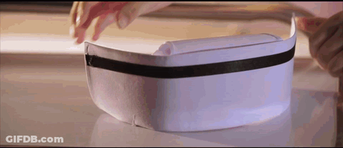 Person Putting On White Hat With Black Ribbon GIF