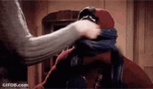 Person Putting Scarf Around Another's Neck GIF