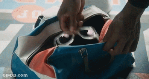 Person Putting Sunglasses In Blue Bag GIF