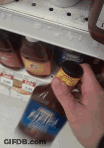 Person Reaching For Barbecue Sauce Bottle GIF
