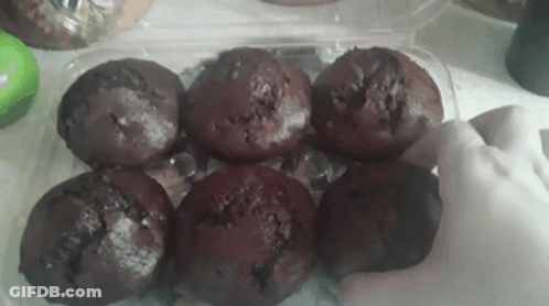 Person Reaching For Chocolate Muffin In Plastic Container GIF