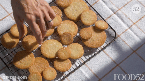Person Reaching For Cookie On Wire Rack Food52 GIF