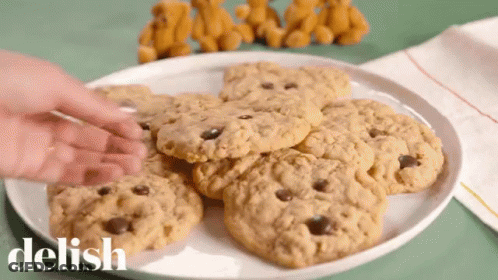 Person Reaching For Cookie Saying Delish GIF