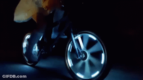 Person Riding Bicycle With Glowing Wheels At Night GIF