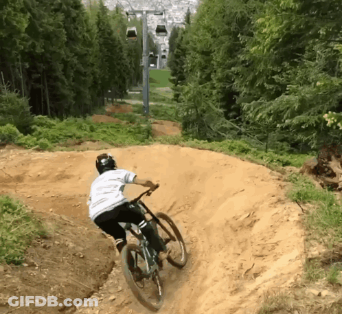 Person Riding Bike Down Dirt Trail GIF