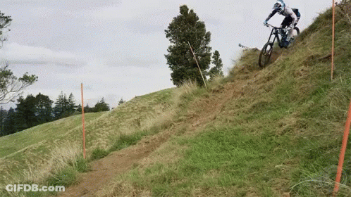 Person Riding Bike Down Hill GIF