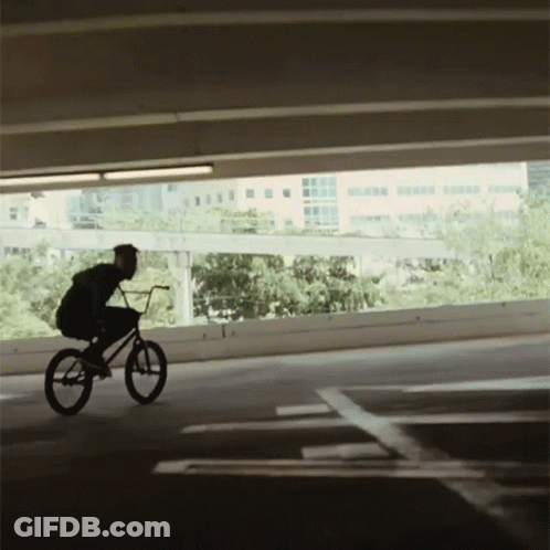 Person Riding Bike In Parking Garage GIF