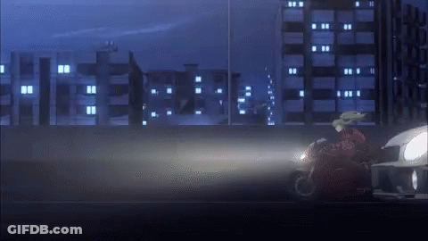 Person Riding Motorcycle Down Road At Night GIF