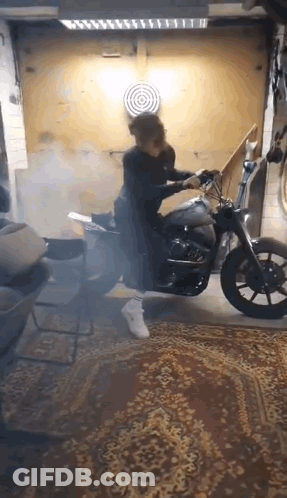 Person Riding Motorcycle In Garage With Smoke GIF