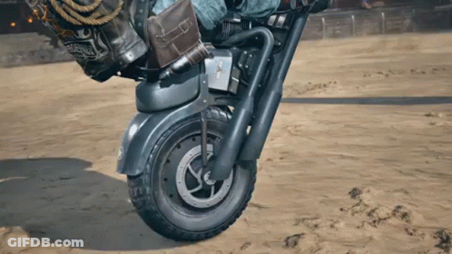 Person Riding Motorcycle In Sand With California Bag GIF