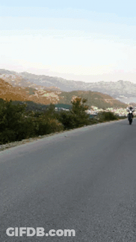 Person Riding Motorcycle On Empty Road GIF