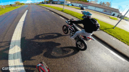 Person Riding Motorcycle Past Building Saying A & A GIF