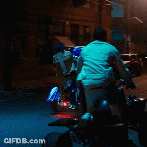 Person Riding Motorcycle With Cross On Back GIF