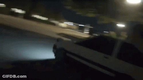 Person Riding Small Car On Sidewalk At Night GIF