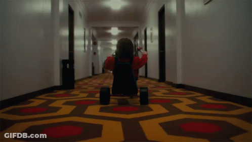 Person Riding Tricycle In Hallway GIF