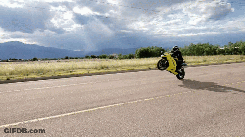 Person Riding Yellow Motorcycle GIF