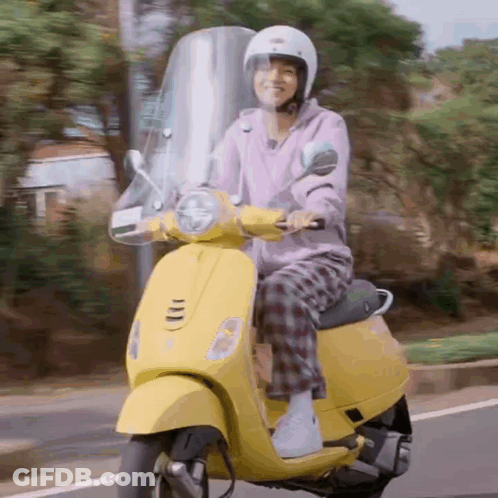 Person Riding Yellow Scooter GIF