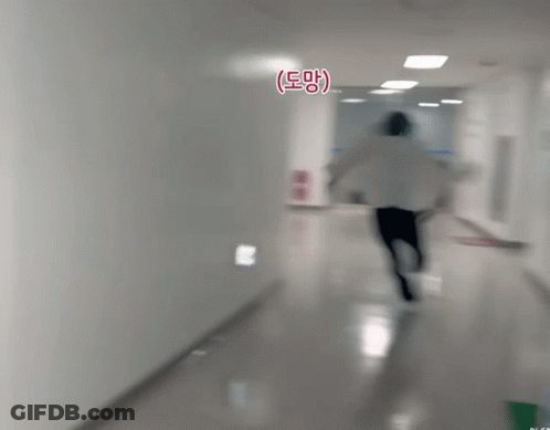 Person Running Down Hallway With Eee Sign GIF