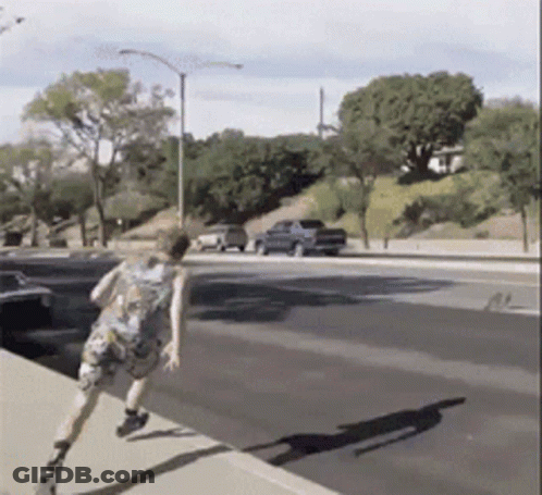 Person Running Down Street With Blue Truck GIF