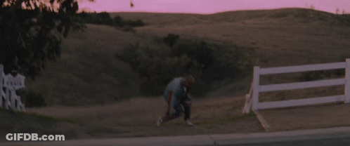 Person Running In Field With Fence GIF