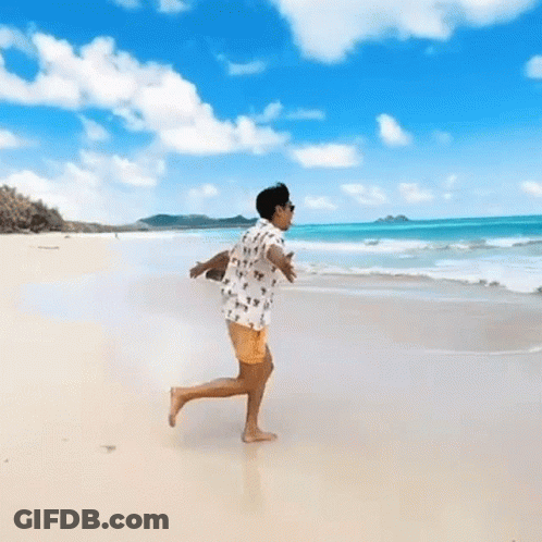 Person Running On Beach With Arms Outstretched GIF