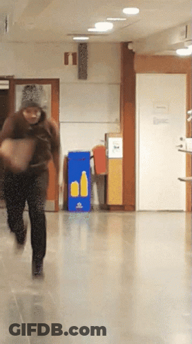 Person Running Past Recycling Sign GIF