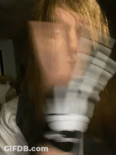 Person's Blurry Face With Cards Behind GIF