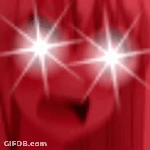 Person's Eyes Shining On Red Background GIF