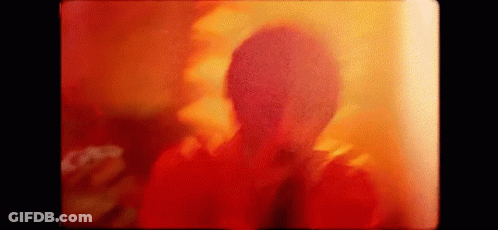 Person's Face Close Up Red Yellow Background GIF