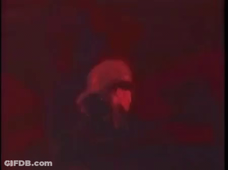Person's Face In Dark Room With Red Lights GIF