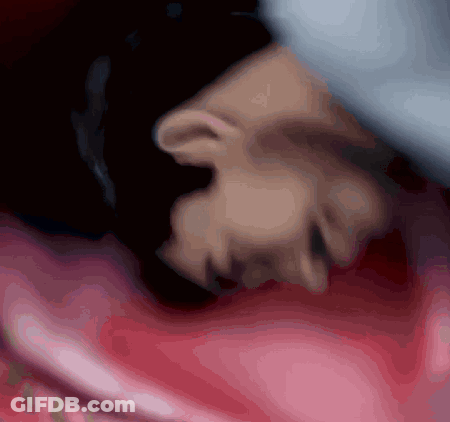 Person's Face Lying On Pink Blanket GIF