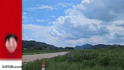 Person's Face Next To Road With Mountains GIF