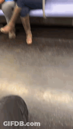Person's Feet Sitting On Train GIF
