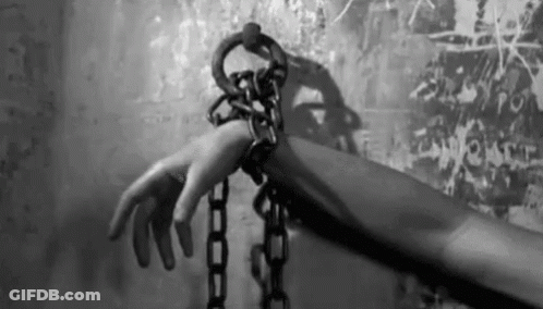 Person's Hand Chained To Wall GIF