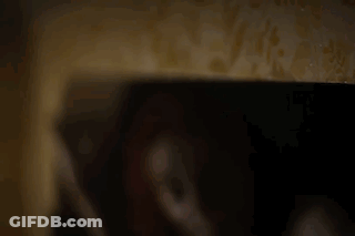 Person's Hand Holding Cell Phone In Dark GIF