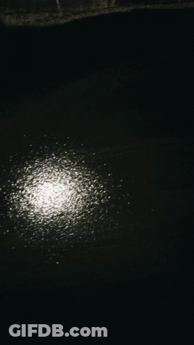 Person's Hand On Black Surface With White Dots GIF