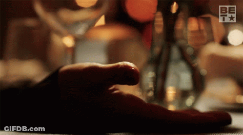 Person's Hand Rests On Table With BETV Logo GIF