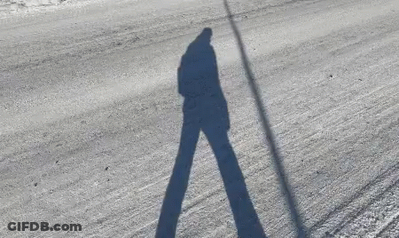 Person's Shadow On Snowy Road GIF