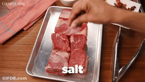 Person Salting Meat GIF